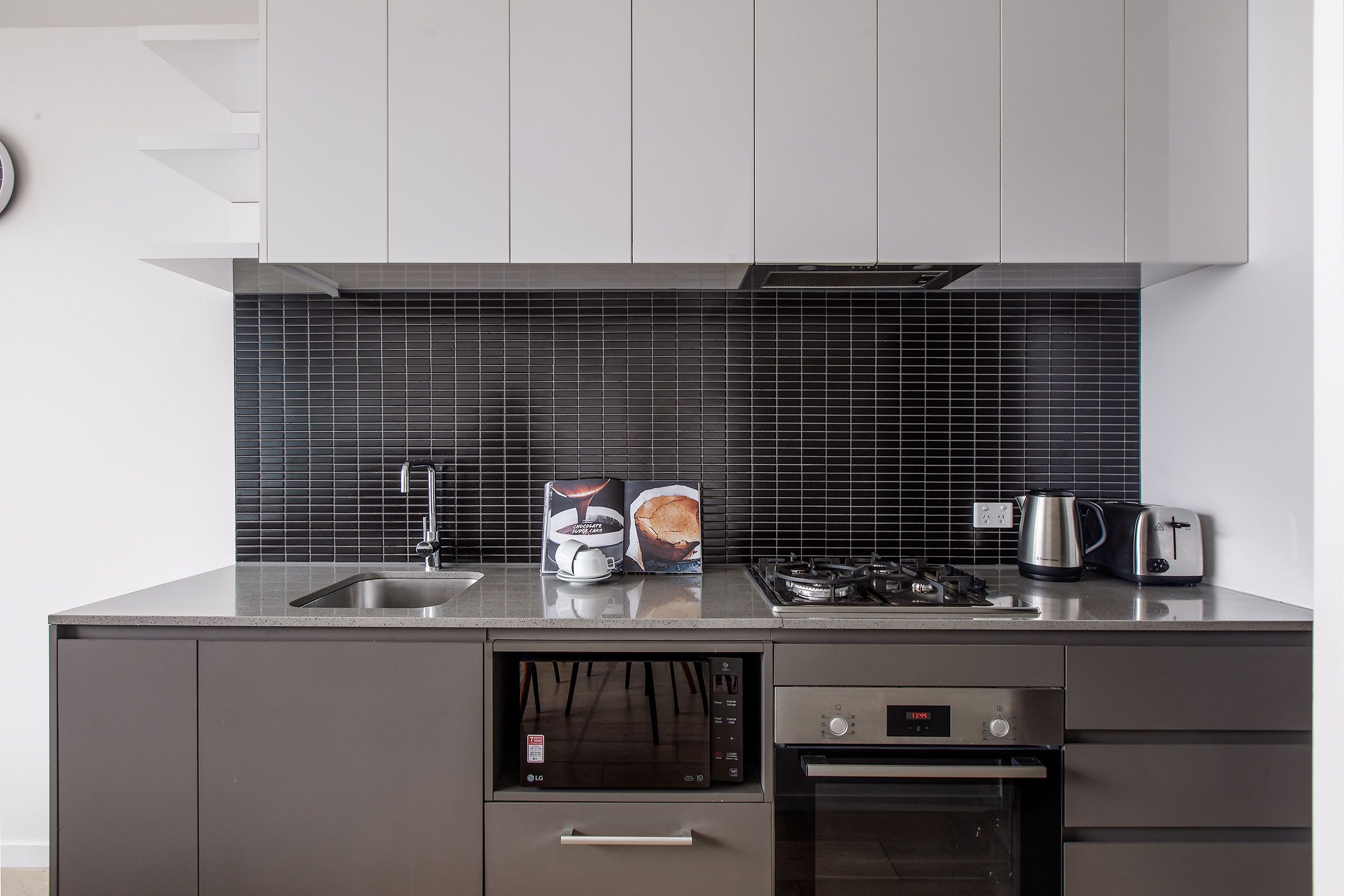 Kitchen with stovetop, oven, and countertop