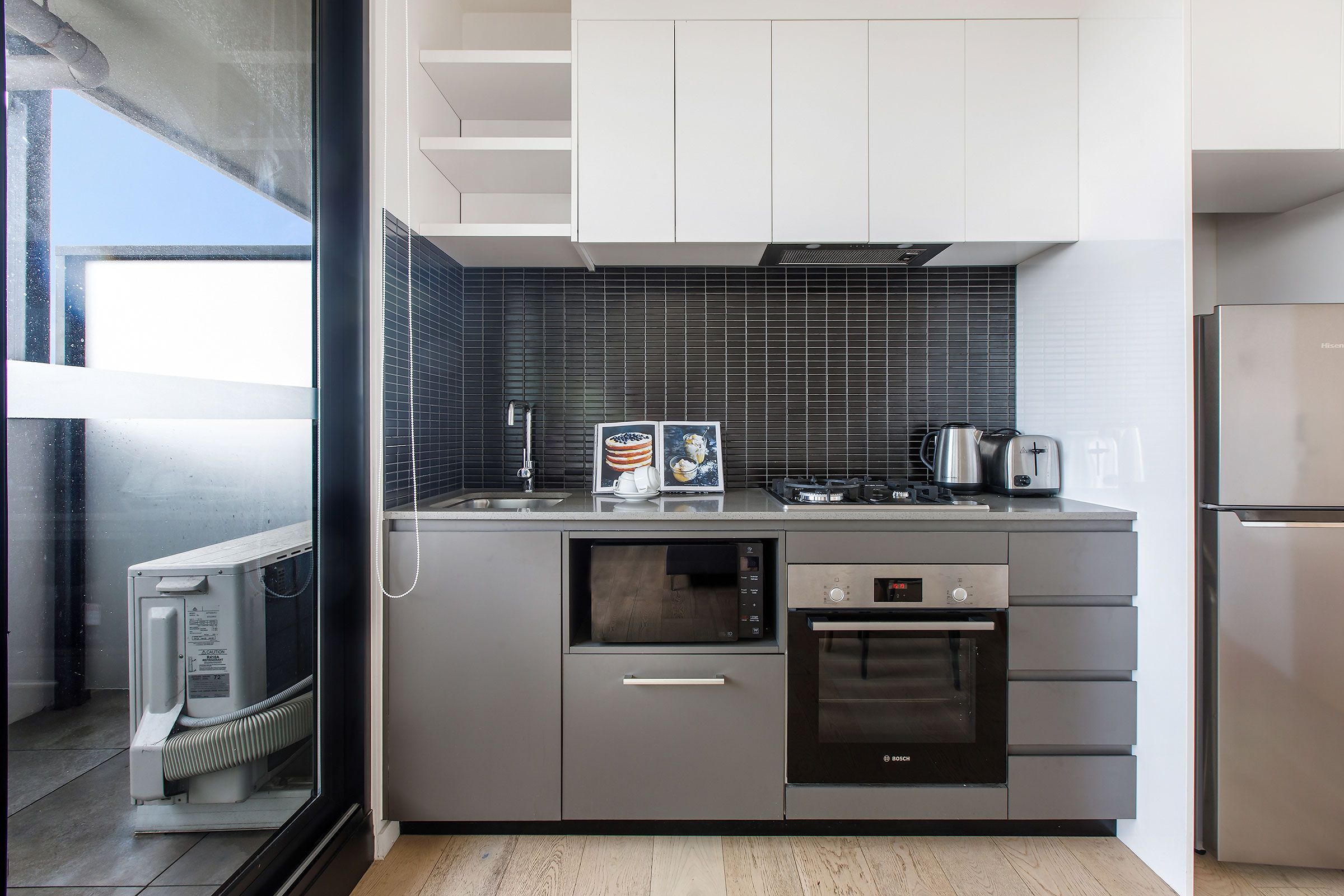 2 Bedroom City View - kitchen with balcony and appliances